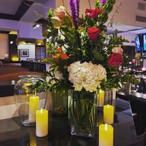 Flowers And Candle Kept on Table