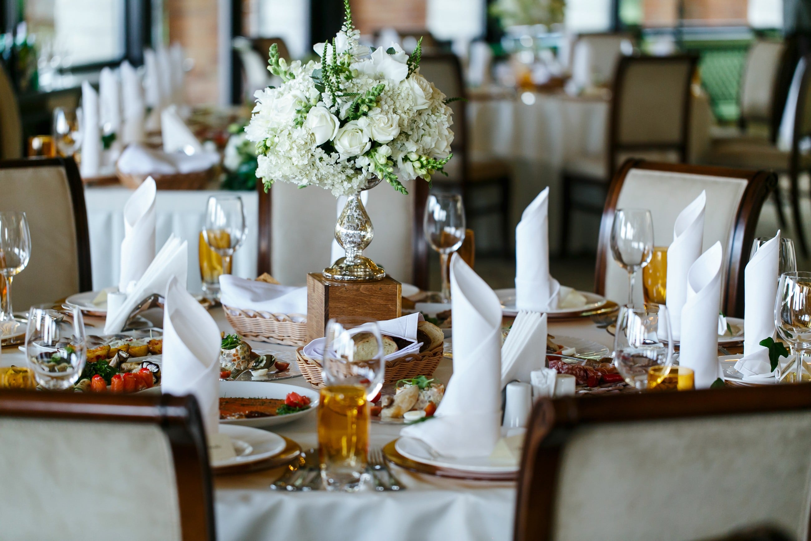 A Table With Glass And Flowers